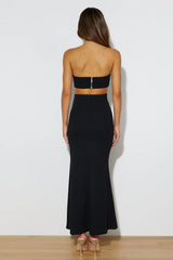 Slim-fitting black evening gown with side cutouts.