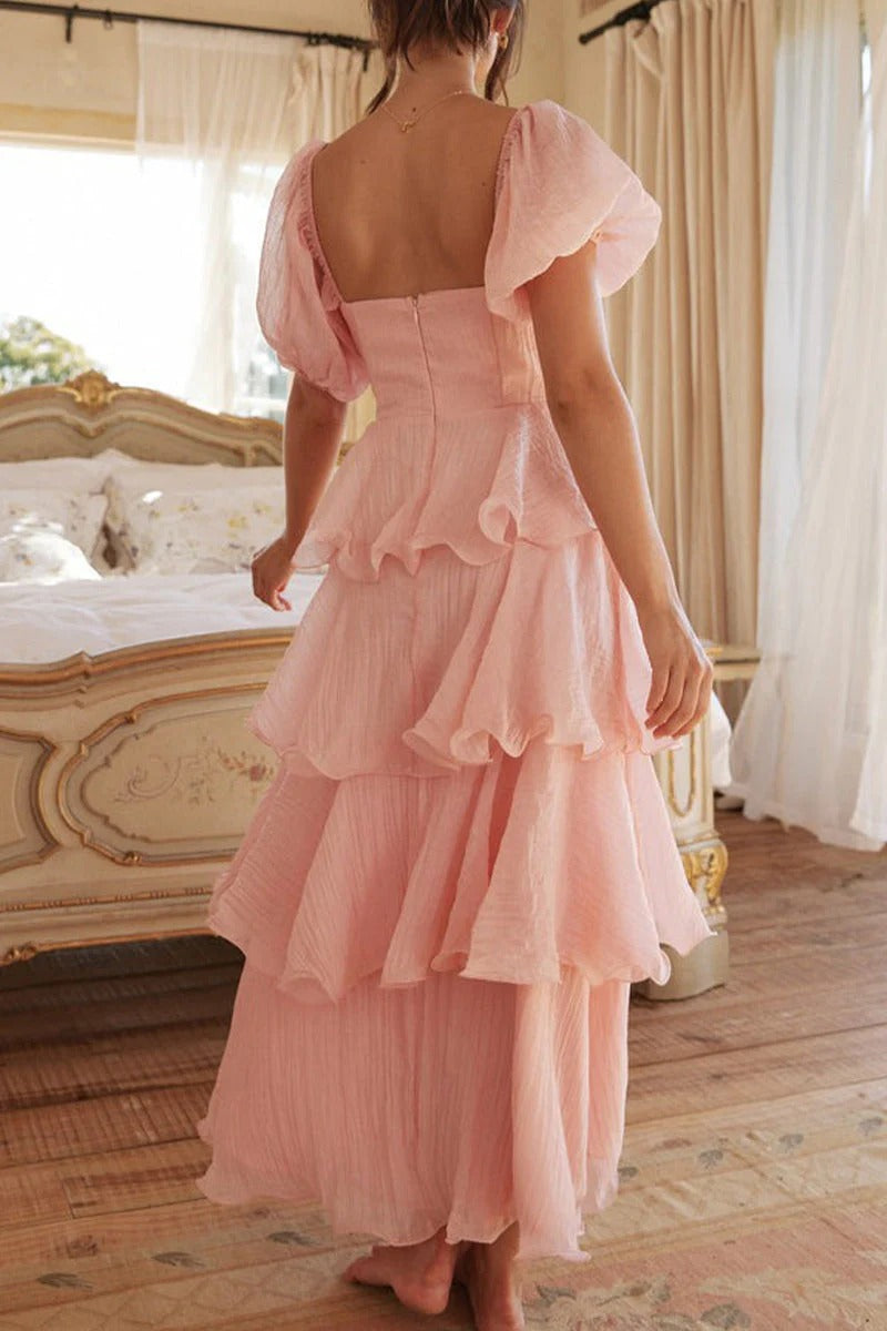 Multi-layered cake skirt with square neckline, open back, and ruffled details.